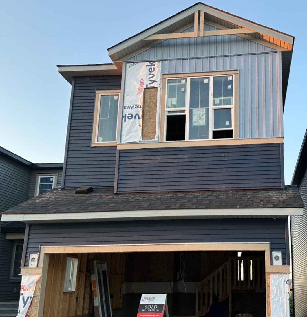 Marmot Passage new build mid-installation with house wrap and vertical accent panel going on